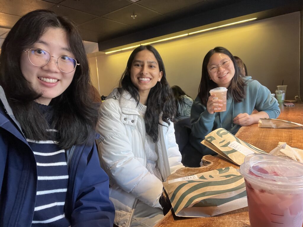Statistics graduate student Yuanbo (left) smiles at Starbucks with Public Health undergraduate students Aparna (middle) and Andrea.