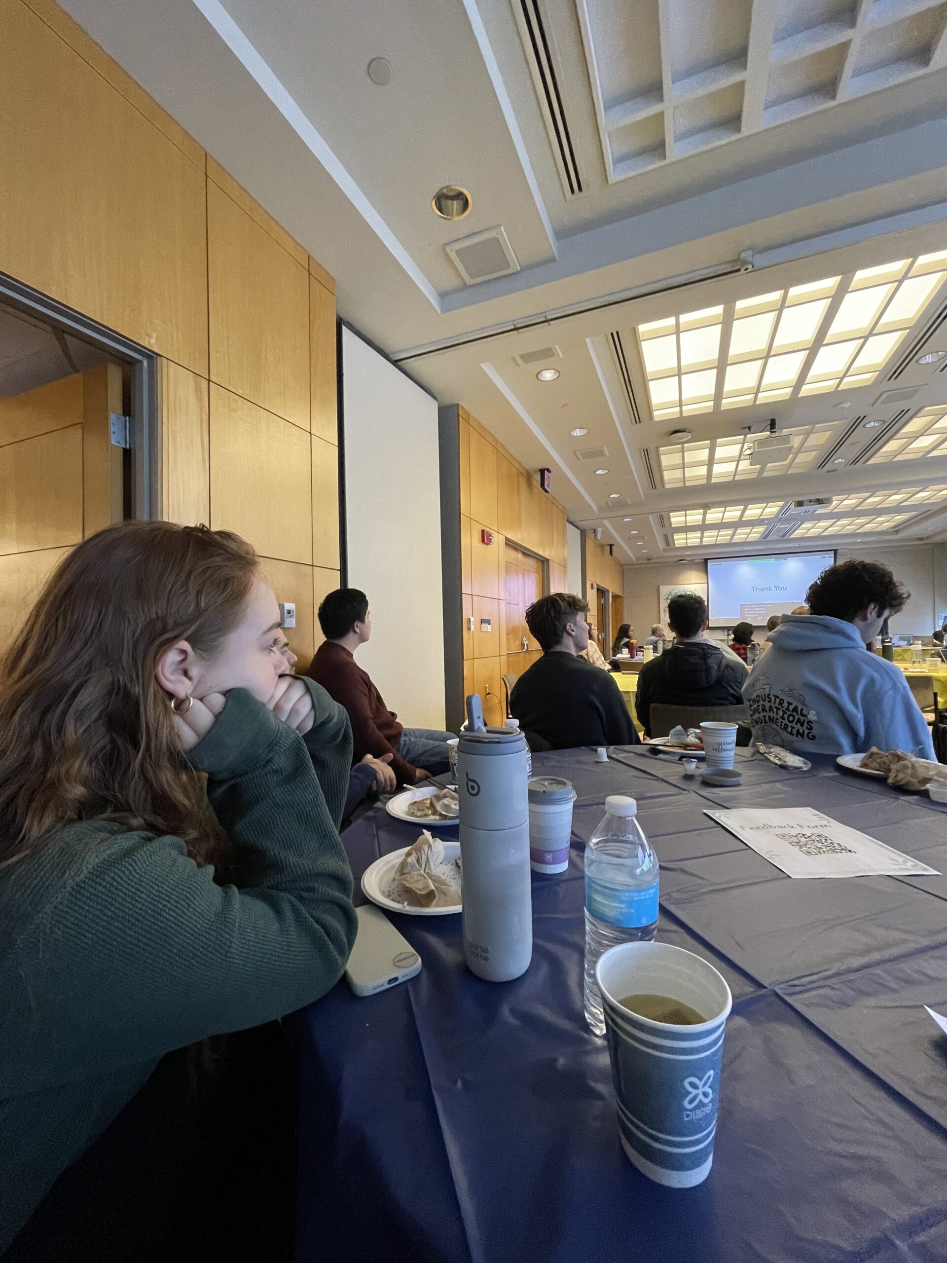 CHEPS students seated at a large blue table while attending the 2024 Disability Visibility Symposium.