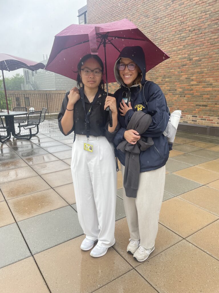 Goretti and Jill getting caught in the rain on their way to the hospital.