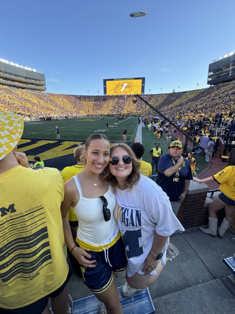 Jill and her teammate, Nikki Watson, catching a Michigan football game.